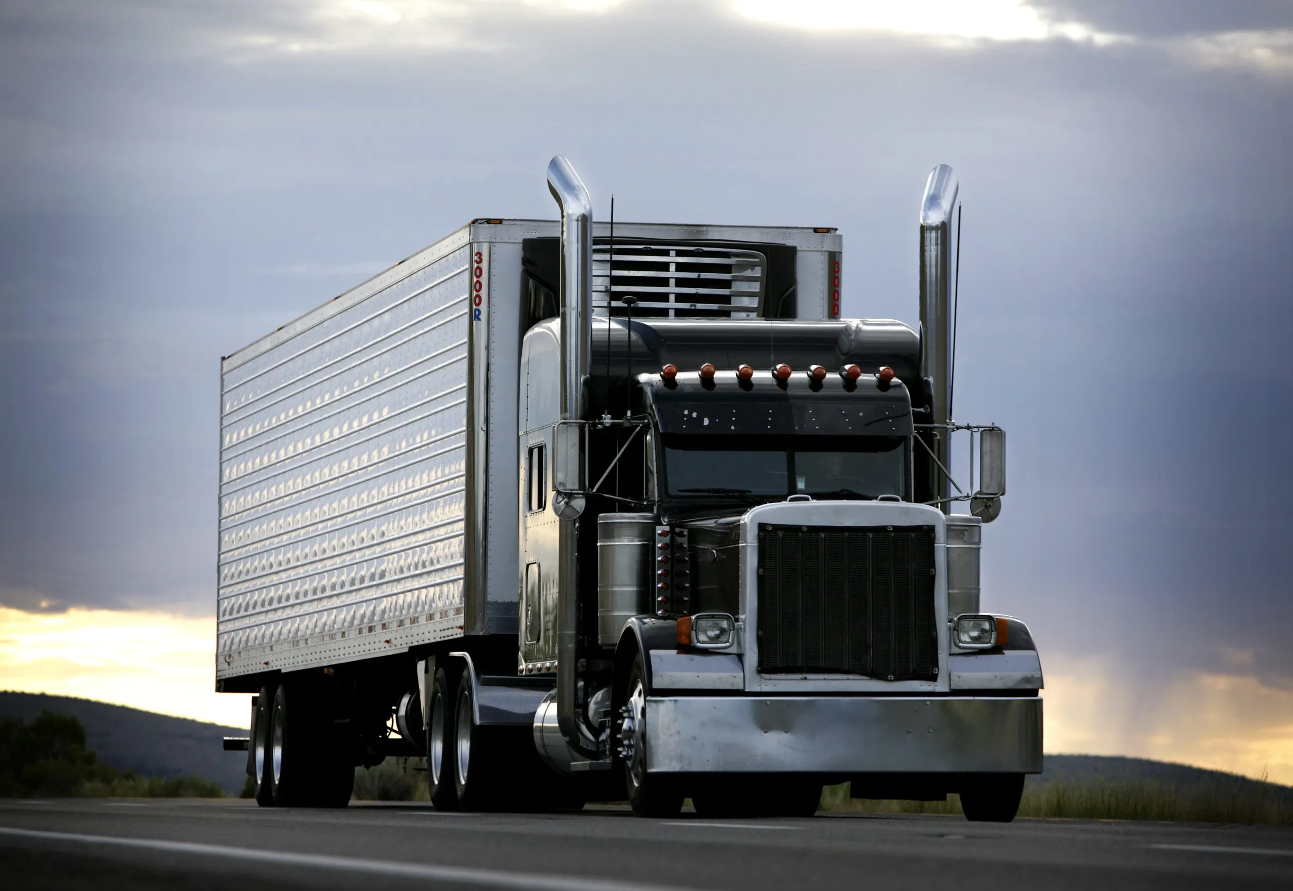 Commercial semi truck sleeper cab driver on route